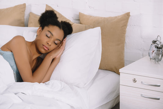 Person sleeping comfortably in a cool room with breathable bedding