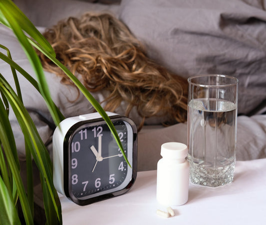 A person took magnesium supplements with a glass of water before bed for better sleep quality.
