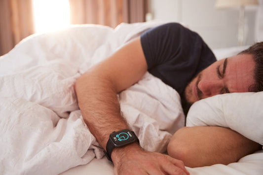 Smartwatch on a wrist tracking sleep patterns during bedtime.