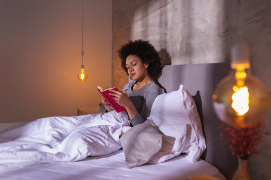 Woman reeding a book book in a cozy bedroom before sleep