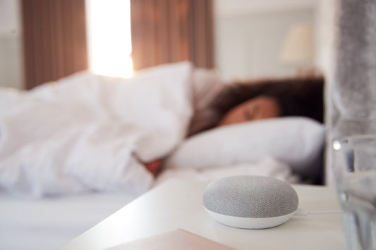 White noise machine on a nightstand creating a peaceful sleep environment.