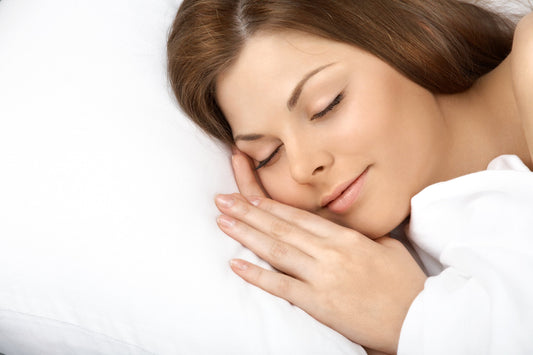 Woman sleeping peacefully with glowing skin and a silk pillowcase