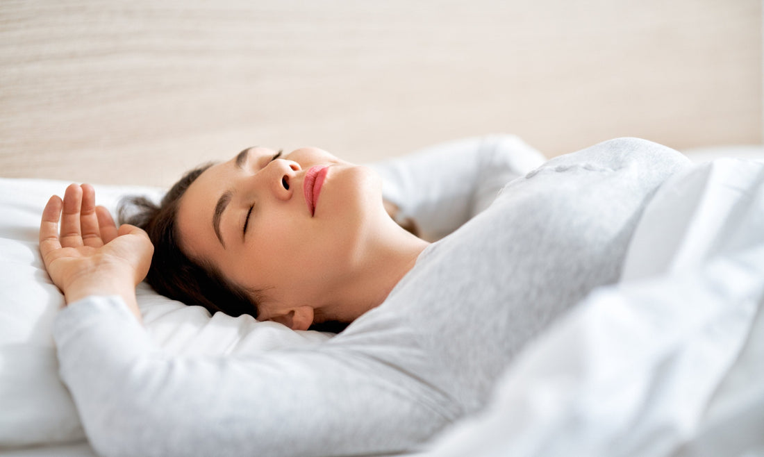 Woman relaxing with eyes closed using breathing techniques at night