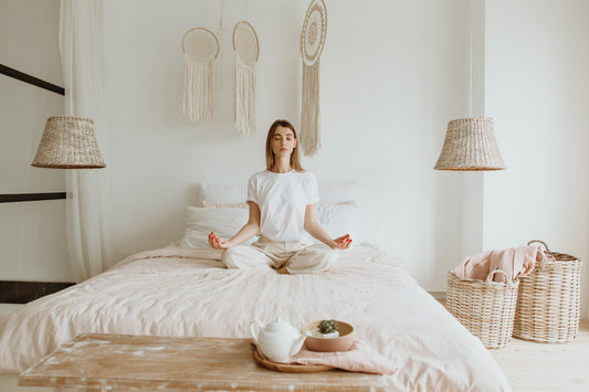 A person relaxing in bed, using relaxation techniques to improve stress and sleep quality.